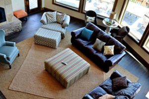 a view down on a comfortable living room with class windows and couches in a vacation home at zion ponderosa ranch