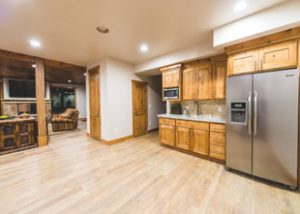 a clean and open kitchen with a large fridge in unit 755