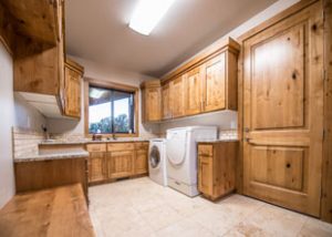 a big laundry room with cabinets has a view of southern Utah