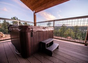 A hot tub sits on a deck with beautiful view of Zion Ponderosa Ranch