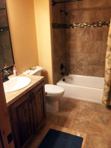 A clean bathroom with a bathtub and shower in unit 756