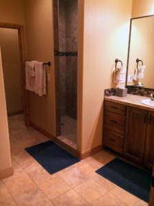 A clean bathroom with an enclosed shower in unit 756