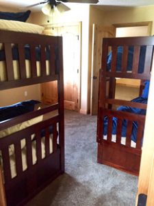Two bunk beds are in a clean bedroom in unit 756