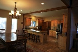 A Large kitchen with granite counter tops and a dining table in a rental home at Zion Ponderosa