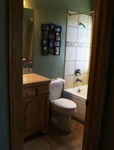 A clean bathroom in a rental home near Zion National Park with pictures on the wall