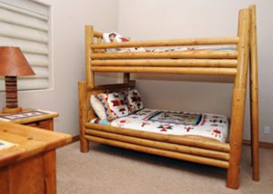 A bunk bed with a wooden frame is in a children's bedroom