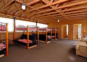 A large room has several bunk beds and futons in a rental unit near zion national park