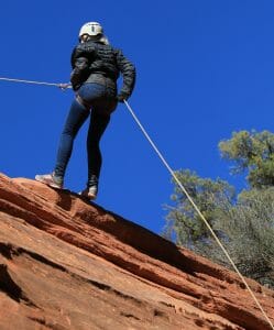 woman rappelling on zion canyoneering adventure