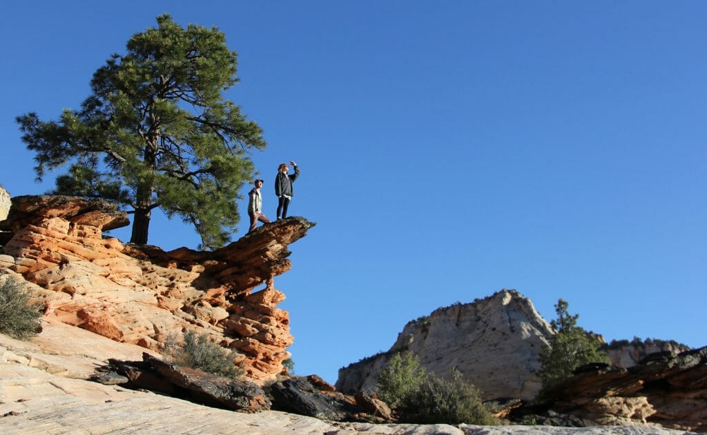 Couple standing on rock point Zion National park