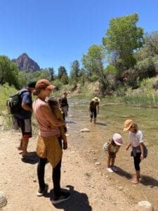 Family cooling off in the virgin river from the Pa'rus Trail