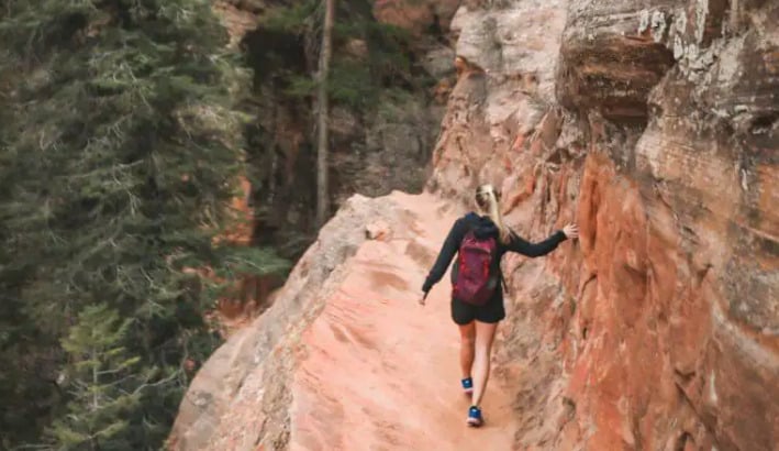 A hiker at zion canyon overlook trail