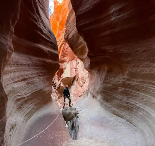 A man exploring a Zion slot canyon