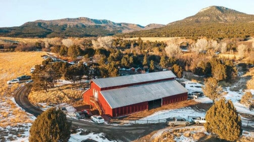A rustic red barn surrounded by beautiful southern Utah scenery is a premier Utah Wedding venue for Zion National Park Weddings.