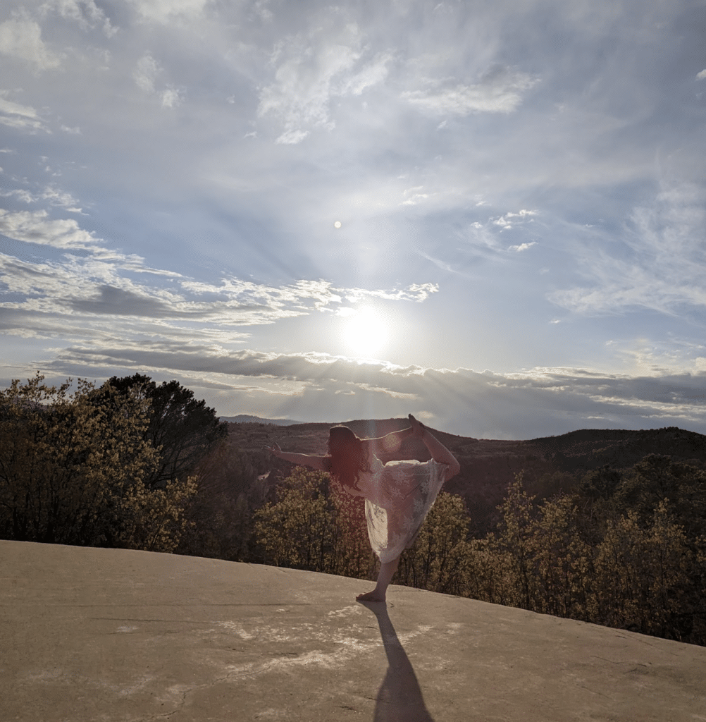 A woman practicing sunset yoga in East Zion