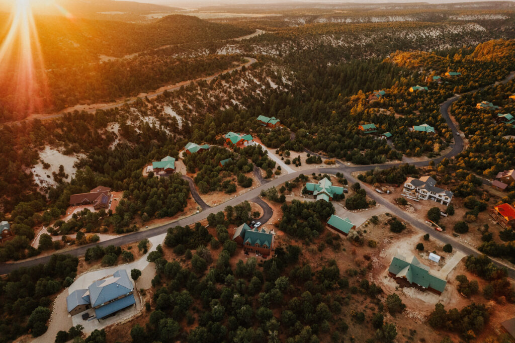 Sun shining on a fall aerial view of Zion Ponderosa