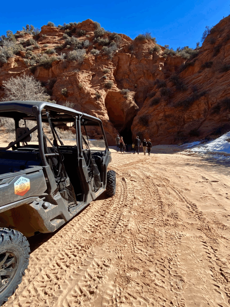 People going into a slot canyon from a UTV